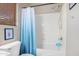 This bright bathroom showcases a shower/tub with a blue shower curtain at 19075 E Pelican Dr, Queen Creek, AZ 85142