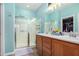 Bathroom featuring a double sink vanity and glass enclosed shower at 19075 E Pelican Dr, Queen Creek, AZ 85142