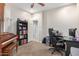 Bedroom with carpet, ceiling fan, a piano, and a bookcase at 19075 E Pelican Dr, Queen Creek, AZ 85142