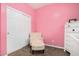 Pink bedroom featuring a chair, closet, and dresser at 19075 E Pelican Dr, Queen Creek, AZ 85142