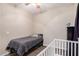 Neutral bedroom with a twin bed, dresser, and a baby crib near a bright window at 19075 E Pelican Dr, Queen Creek, AZ 85142