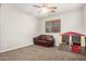 Carpeted bonus room with a window, fan, and a small sofa at 19075 E Pelican Dr, Queen Creek, AZ 85142