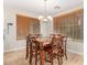 Dining area featuring a chandelier above a wooden table with seating for six at 19075 E Pelican Dr, Queen Creek, AZ 85142