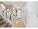 Bright entryway featuring wood-look floors and a staircase on the left at 19075 E Pelican Dr, Queen Creek, AZ 85142