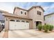 Two-story home with a well-maintained front yard and a two-car garage at 19075 E Pelican Dr, Queen Creek, AZ 85142