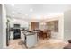 Bright kitchen featuring white cabinets, stainless appliances, and an island with a sink at 19075 E Pelican Dr, Queen Creek, AZ 85142