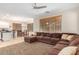 Living room featuring a sectional sofa, adjoining the kitchen and dining area at 19075 E Pelican Dr, Queen Creek, AZ 85142