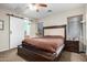 Main bedroom featuring a barn door to bathroom and three windows at 19075 E Pelican Dr, Queen Creek, AZ 85142