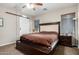 Main bedroom featuring a barn door to bathroom and three windows at 19075 E Pelican Dr, Queen Creek, AZ 85142