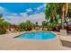 Sparkling community pool with lounge chairs surrounded by lush landscaping at 19075 E Pelican Dr, Queen Creek, AZ 85142