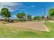 Community sand volleyball court adjacent to lush green space at 19075 E Pelican Dr, Queen Creek, AZ 85142