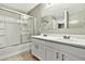 Bathroom with double sinks, white vanity, tiled floor, and shower-tub combination at 2210 E Caspian Way, San Tan Valley, AZ 85140