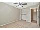 Carpeted bedroom features a ceiling fan and closet with shelving for ample storage at 2210 E Caspian Way, San Tan Valley, AZ 85140