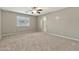 Bedroom with carpet flooring, ceiling fan and a view to the bathroom at 2210 E Caspian Way, San Tan Valley, AZ 85140