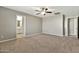 Bedroom with carpet flooring, ceiling fan, and doorway to bathroom at 2210 E Caspian Way, San Tan Valley, AZ 85140