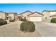 Charming single-story home with a well-manicured desert landscape and a two-car garage at 2210 E Caspian Way, San Tan Valley, AZ 85140