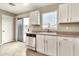 Kitchen with stainless steel dishwasher and white cabinets, plus sliding glass doors to the back patio at 2210 E Caspian Way, San Tan Valley, AZ 85140