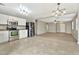 Open-concept kitchen with stainless steel appliances, white cabinets, and tile flooring at 2210 E Caspian Way, San Tan Valley, AZ 85140