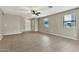 Open and bright living room featuring tile flooring and natural lighting from the windows at 2210 E Caspian Way, San Tan Valley, AZ 85140