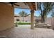 Covered patio overlooking landscaped backyard with artificial turf, and desert plants at 2416 E Cielo Grande Ave, Phoenix, AZ 85024