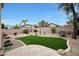 Landscaped backyard with artificial turf, desert plants, and a brick perimeter fence at 2416 E Cielo Grande Ave, Phoenix, AZ 85024