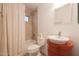 Well-lit bathroom featuring a vessel sink, neutral tile, and a shower-tub combo at 2416 E Cielo Grande Ave, Phoenix, AZ 85024