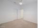 Bedroom featuring neutral carpet, white walls, ceiling fan, and closet with sliding doors at 2416 E Cielo Grande Ave, Phoenix, AZ 85024