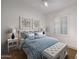 Bedroom with a white bed frame, blue and white bedding, and a white bench at 2416 E Cielo Grande Ave, Phoenix, AZ 85024