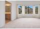 Bright bedroom with large windows showcasing outdoor scenery and an adjacent bathroom at 2416 E Cielo Grande Ave, Phoenix, AZ 85024