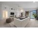 Bright living room with white walls, a ceiling fan, and sliding glass doors to the backyard at 2416 E Cielo Grande Ave, Phoenix, AZ 85024