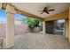 The covered patio offers a ceiling fan, brick pavers, and backyard access at 2416 E Cielo Grande Ave, Phoenix, AZ 85024