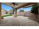 Covered patio with brick flooring, fire pit, column supports, and backyard landscaping at 2416 E Cielo Grande Ave, Phoenix, AZ 85024