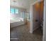 Bathroom with a tiled floor, soaking tub, glass shower, and natural light from the windows at 2539 E Hazeltine Way, Chandler, AZ 85249