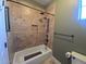 Shower and toilet featuring neutral tones and a tiled shower and tiled floors at 2539 E Hazeltine Way, Chandler, AZ 85249