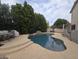 Backyard pool featuring rock accents, a stone border, and patio umbrella at 2539 E Hazeltine Way, Chandler, AZ 85249