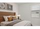 Serene bedroom with a wooden headboard, soft lighting, and a view through the window at 25401 W Sunland Ave, Buckeye, AZ 85326