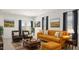 Cozy living room with an orange sofa set and patterned rug at 25401 W Sunland Ave, Buckeye, AZ 85326