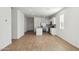 Open-concept living room with wood-look tile flooring and a view of the kitchen at 25401 W Sunland Ave, Buckeye, AZ 85326