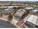 Aerial view of a well-maintained home with a two car garage surrounded by desert landscaping and green lawns at 2568 N Armour Ave, Mesa, AZ 85215