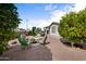 A spacious backyard featuring desert landscaping with a fire pit area and covered patio for relaxation and outdoor enjoyment at 2568 N Armour Ave, Mesa, AZ 85215