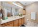 Bathroom featuring dual sinks, spacious vanity, neutral tones, and framed mirror at 2568 N Armour Ave, Mesa, AZ 85215