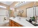 Clean bathroom with generous countertop space, bathtub with shower, and modern light fixture at 2568 N Armour Ave, Mesa, AZ 85215