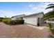 Exterior view of a well-maintained house featuring desert landscaping, including gravel and greenery, offering curb appeal at 2568 N Armour Ave, Mesa, AZ 85215