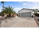 A well-kept home featuring a spacious three-car garage and meticulously maintained desert landscaping at 2568 N Armour Ave, Mesa, AZ 85215