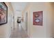 Bright hallway with tile flooring, connecting various rooms and leading to a sunlit living area at 2568 N Armour Ave, Mesa, AZ 85215