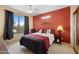 Charming main bedroom with a patterned bedspread, warm tones, and a window overlooking the neighborhood at 2568 N Armour Ave, Mesa, AZ 85215