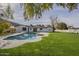 The backyard features a pool with a grassy lawn and mature trees in a large yard at 2902 E Pierson St, Phoenix, AZ 85016