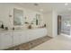 Bathroom featuring double sink vanity, decorative mirrors, and modern sconces at 2902 E Pierson St, Phoenix, AZ 85016