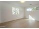 This bedroom is well-lit from two windows, featuring light hardwood floors and neutral paint at 2902 E Pierson St, Phoenix, AZ 85016