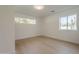 Simple yet stylish bedroom with hardwood floors and natural light from large windows at 2902 E Pierson St, Phoenix, AZ 85016